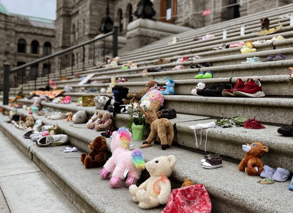 Children's toys and shoes line concrete stairs