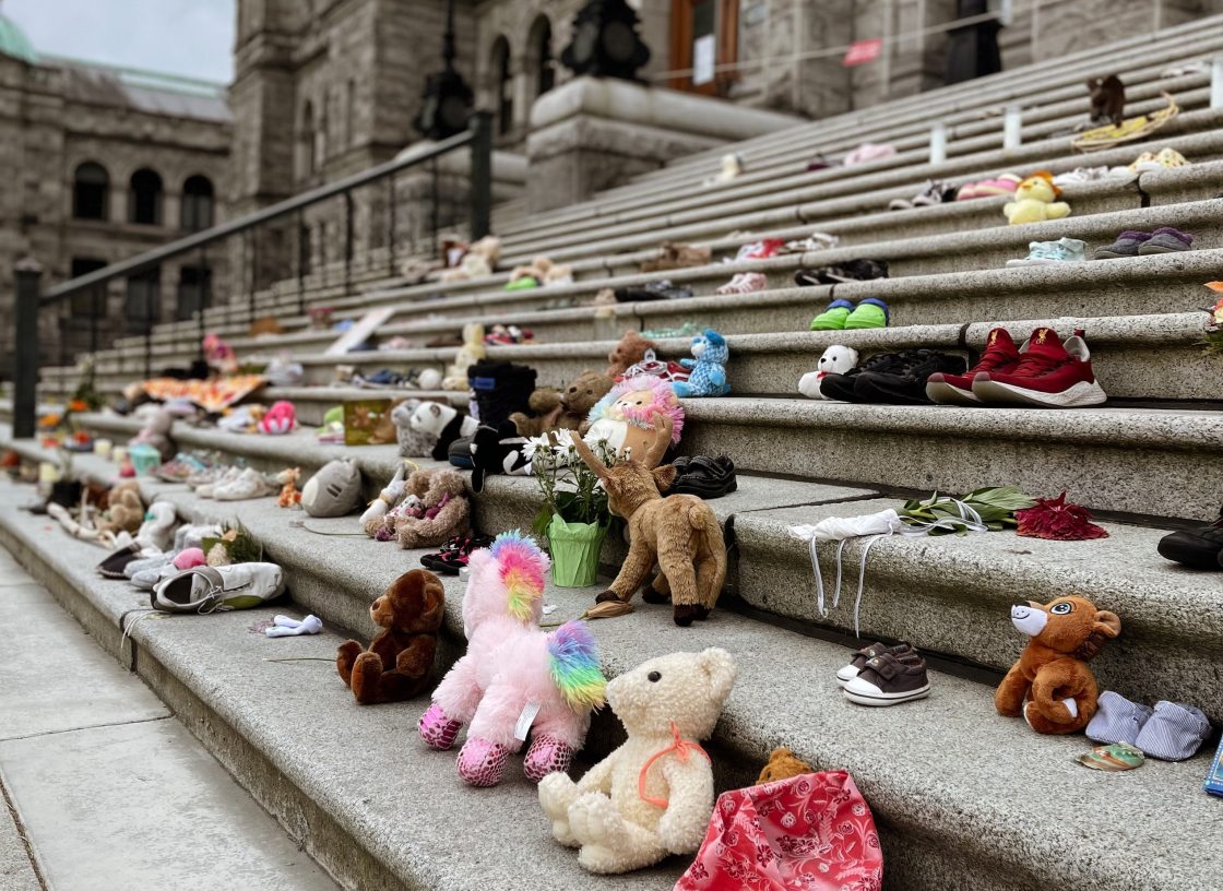 Children's toys and shoes line concrete stairs